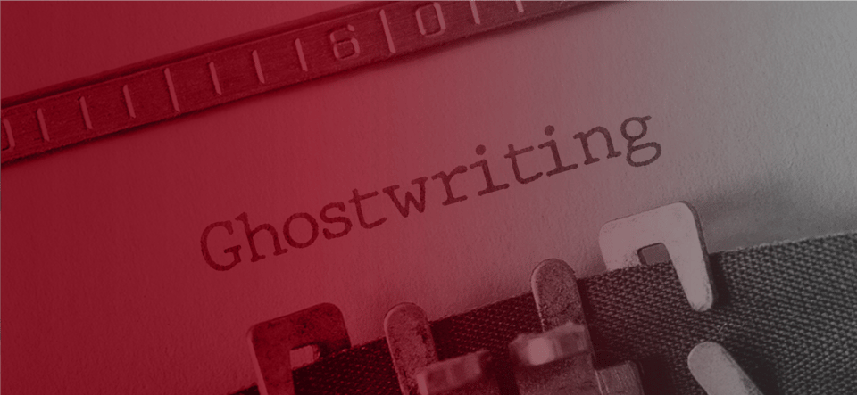 Open laptop displaying a marketing webpage with notepads and a pen nearby